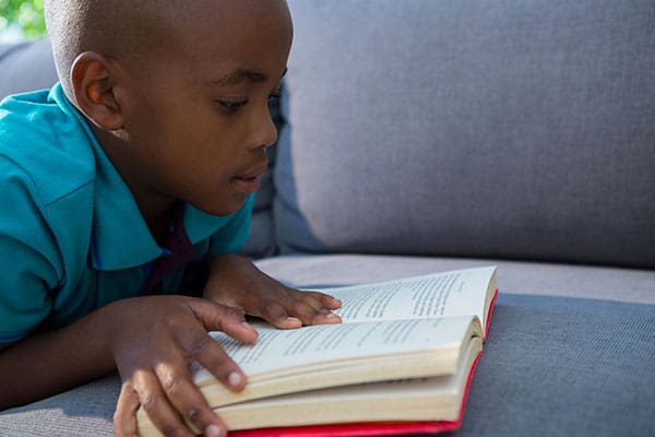 boy reading a chapter book